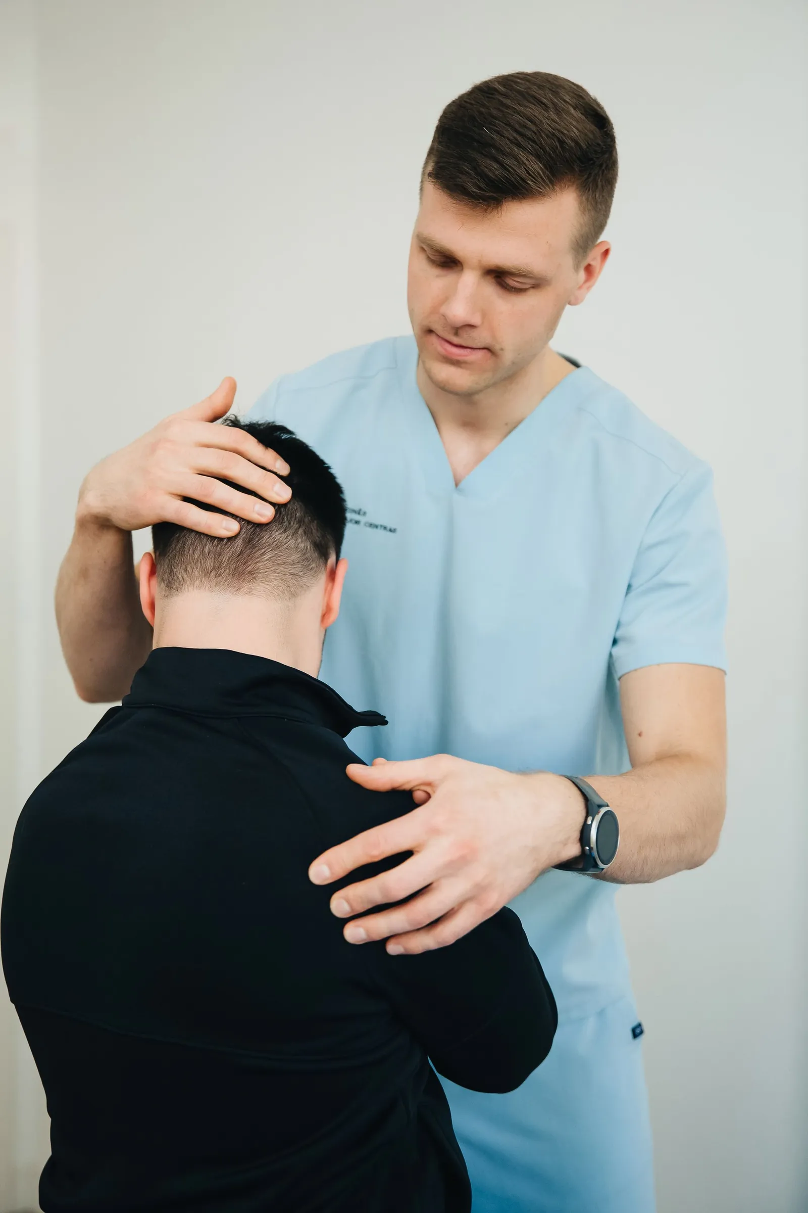 Clinician examining a patient’s neck