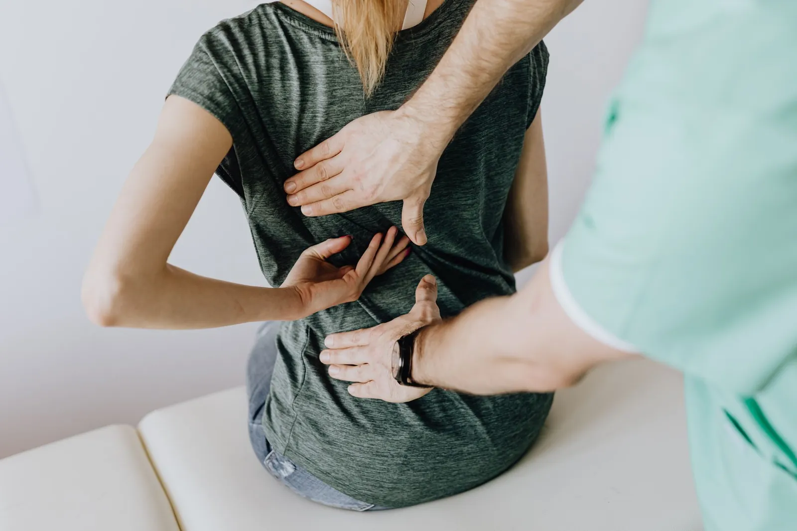 Chiropractor examining a patient’s back