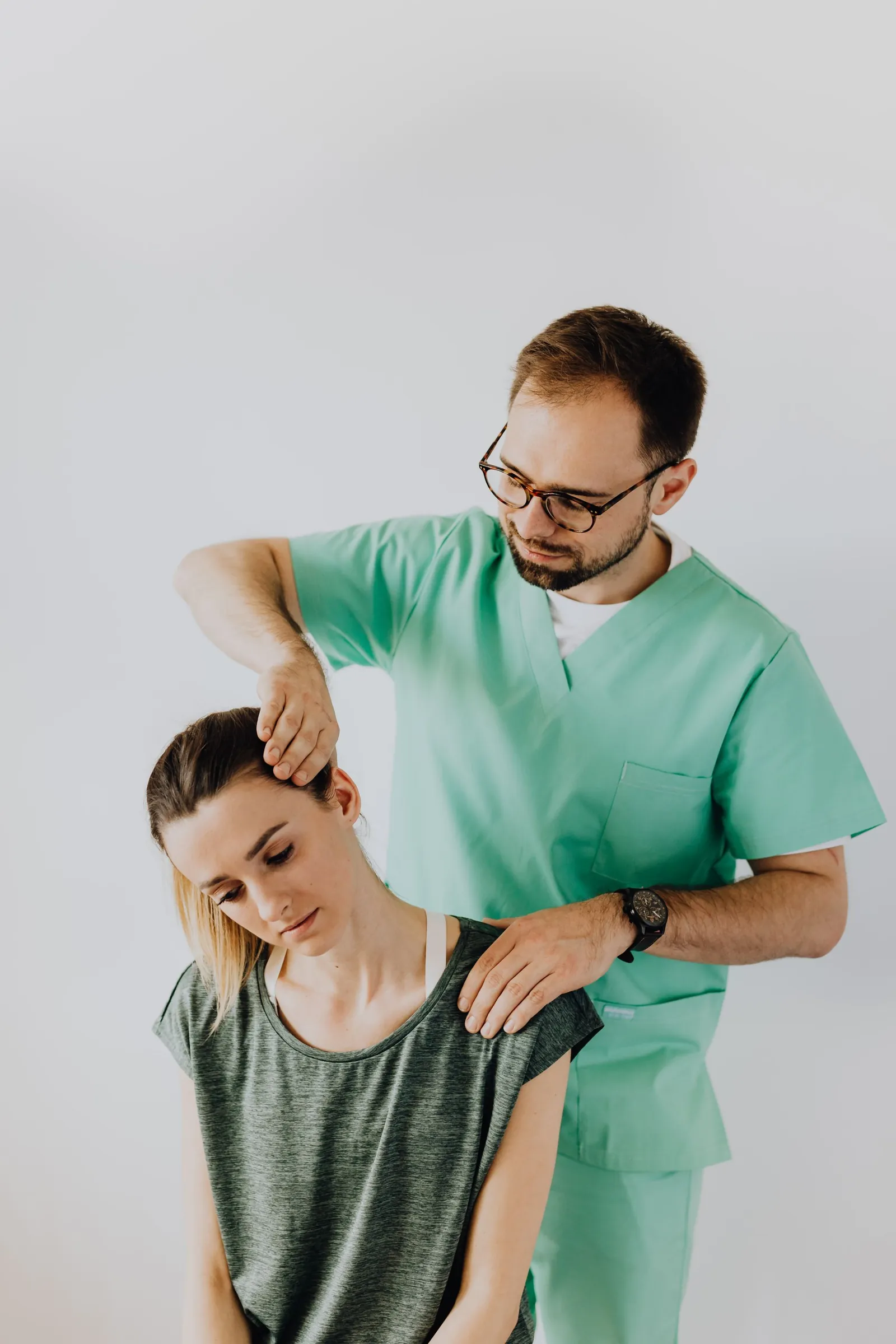 Clinician assessing a patient’s neck