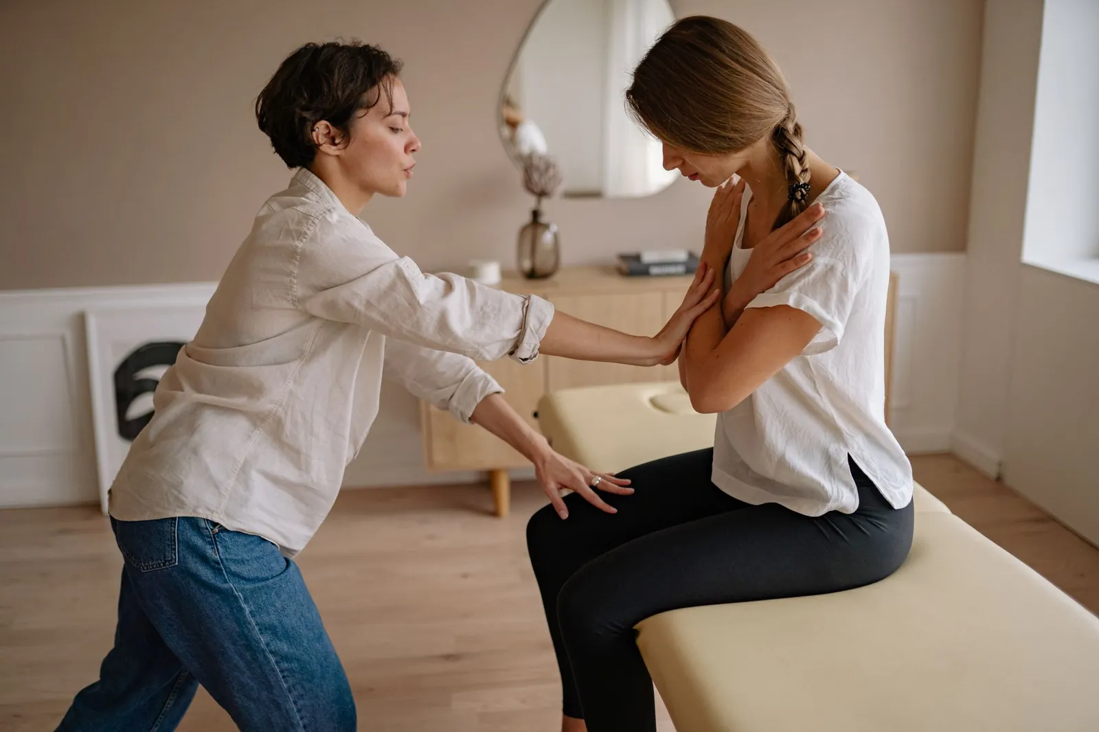 Therapist supporting a seated patient